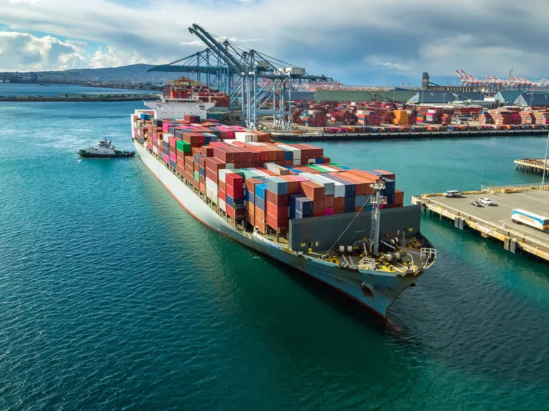 A cargo ship arriving at a container port